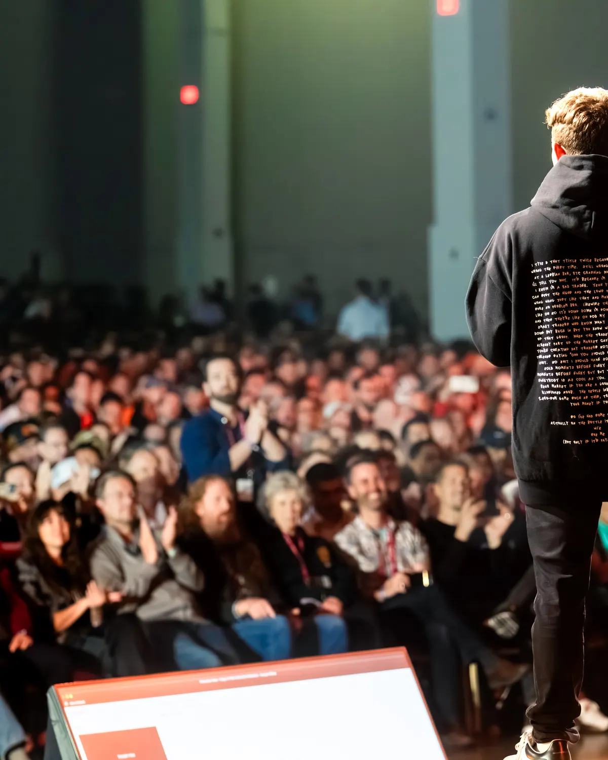 Speaker addressing a packed Bitcoin conference crowd